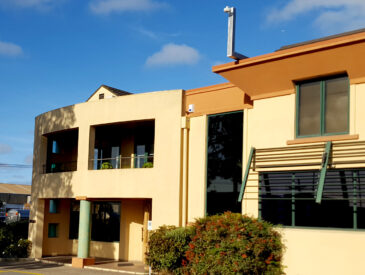Photo of a commercial building on a blue sky & sunny day