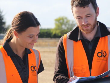 Two people dressed in high visibility vests