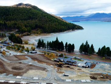 Aerial view of Station Bay residential development in progress with hills and mountains in the background