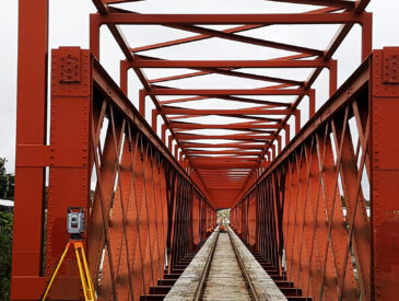 View of a railway bridge and survey equipment beside