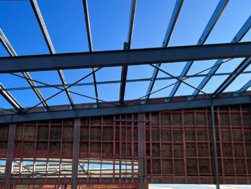 Photo of steel structural beams with blue sky in the background