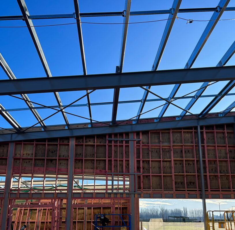 Photo of steel structural beams with blue sky in the background