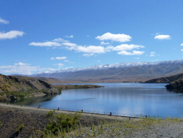 View of water with mountains in the background on a sunny day