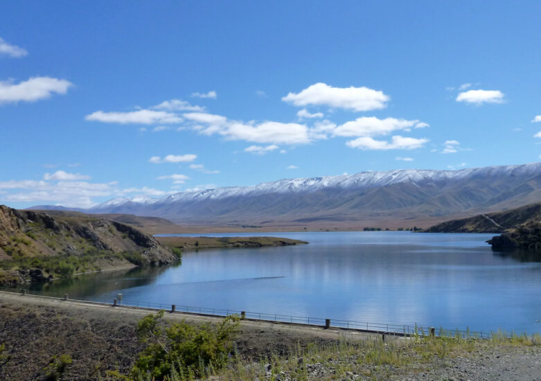 View of water with mountains in the background on a sunny day