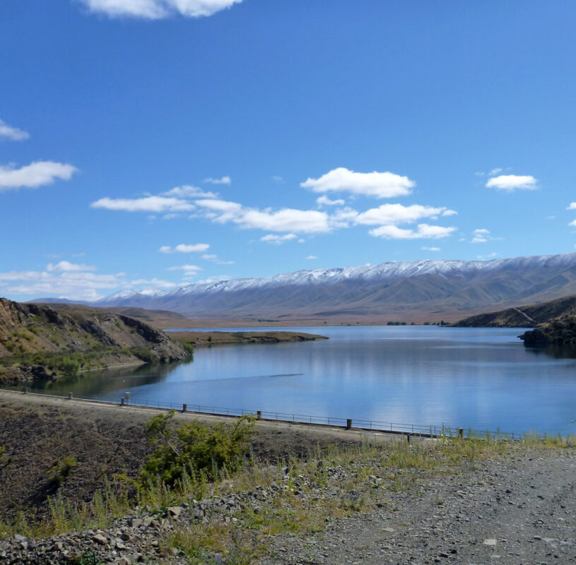 View of water with mountains in the background on a sunny day