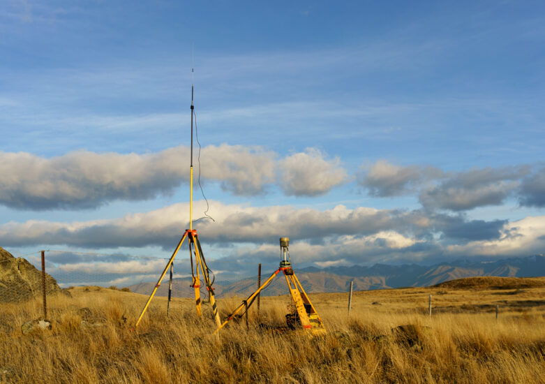Survey equipment in a field on a sunny day