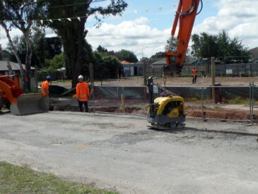 Construction in progress with various heavy machinery in open land